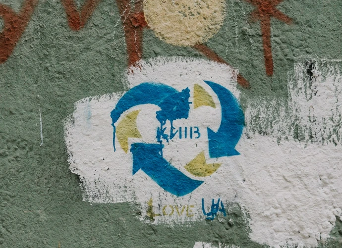 graffiti on the side of a building with a white fire hydrant